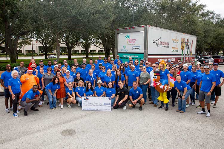 Team Members posing with Thanksgiving Drive food donations