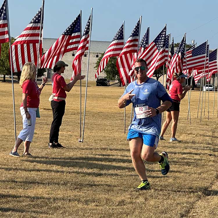 A David Weekley Homes Team Member in Austin at the finish line at a fun run