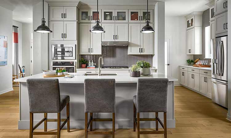 a kitchen with an island in a David Weekley Homes model home