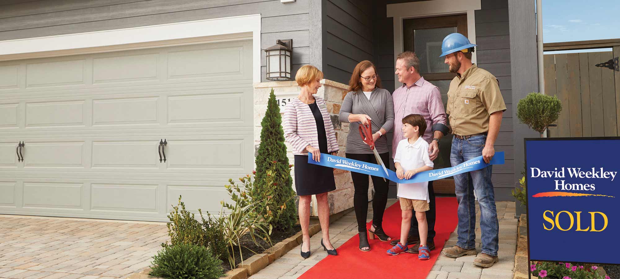 A David Weekley Homes Sales Consultant and Builder welcoming a family to their new home
