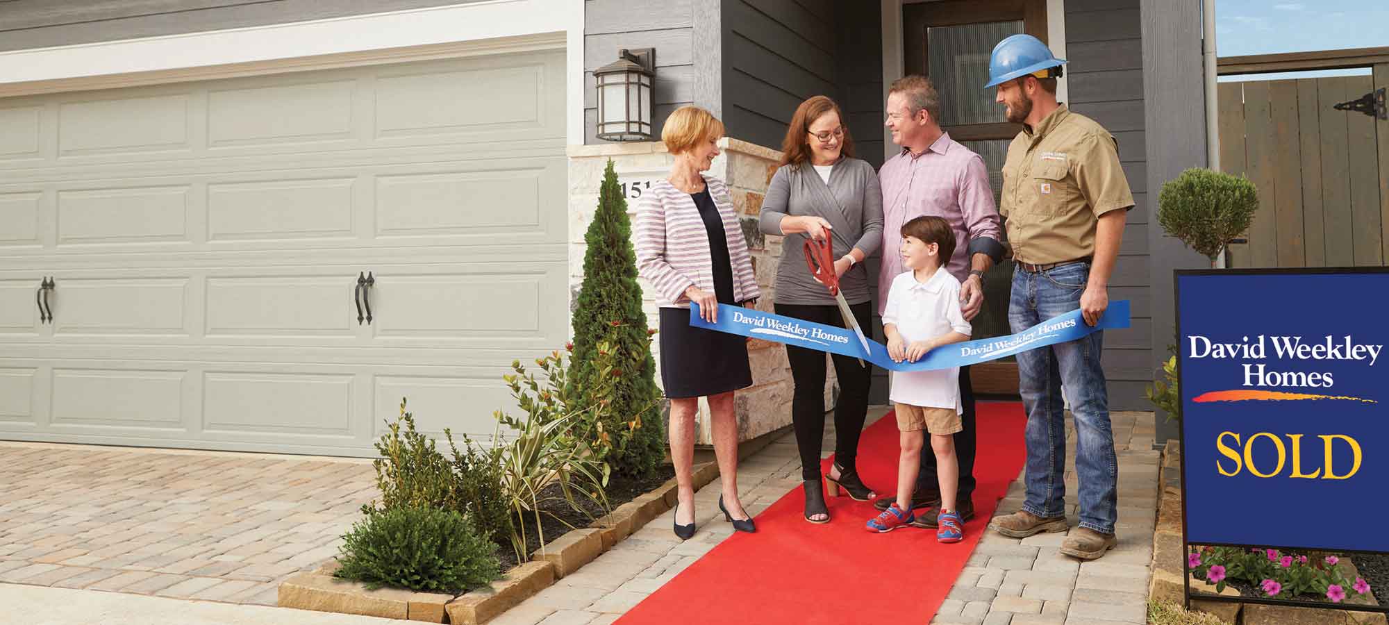 A David Weekley Homes Sales Consultant and Personal Builder welcome a family to their new home