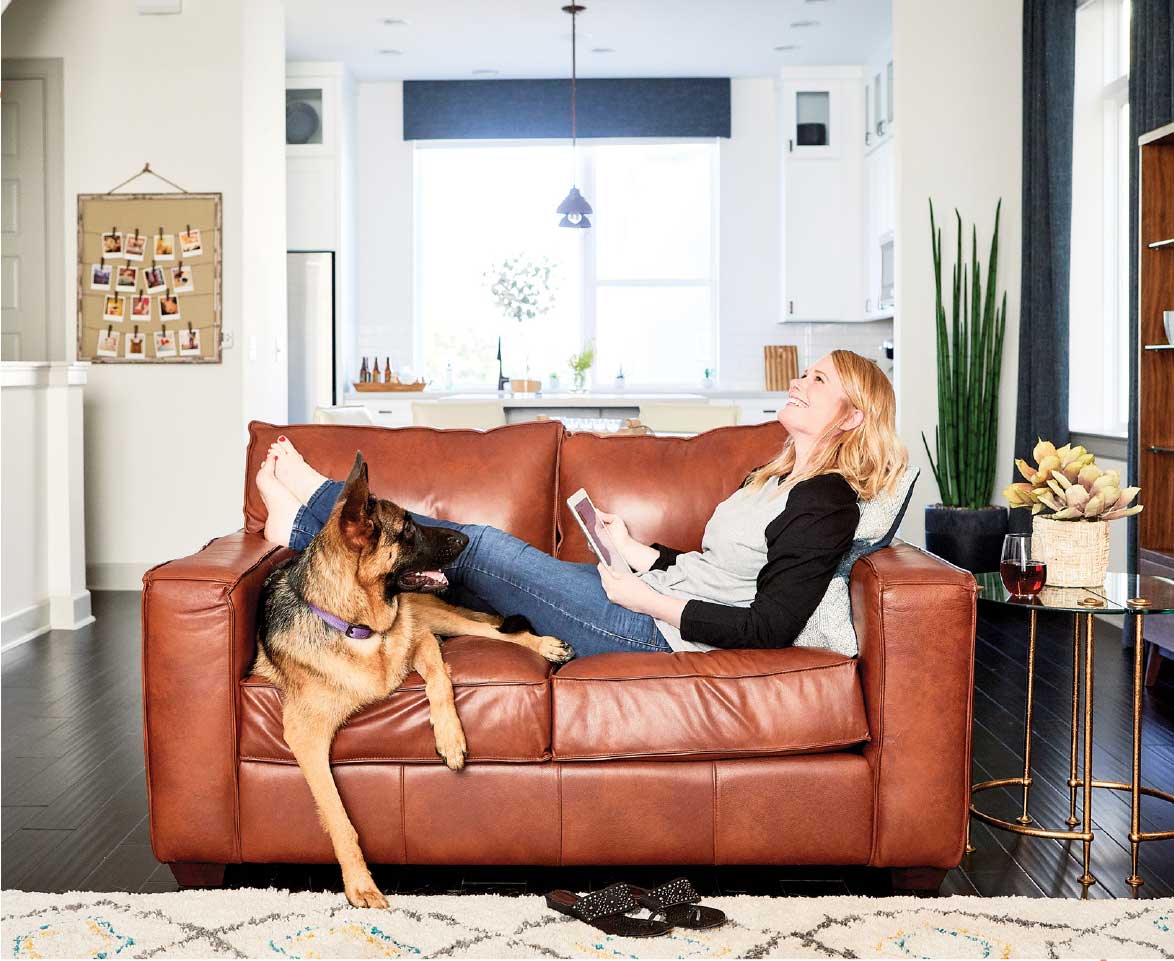 A David Weekley Homeowner lounging on a couch with dog
