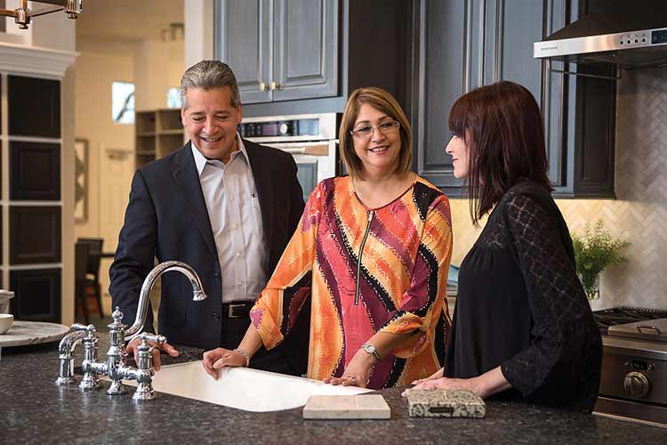 A David Weekley Homes Design Consultant shows customers kitchen options